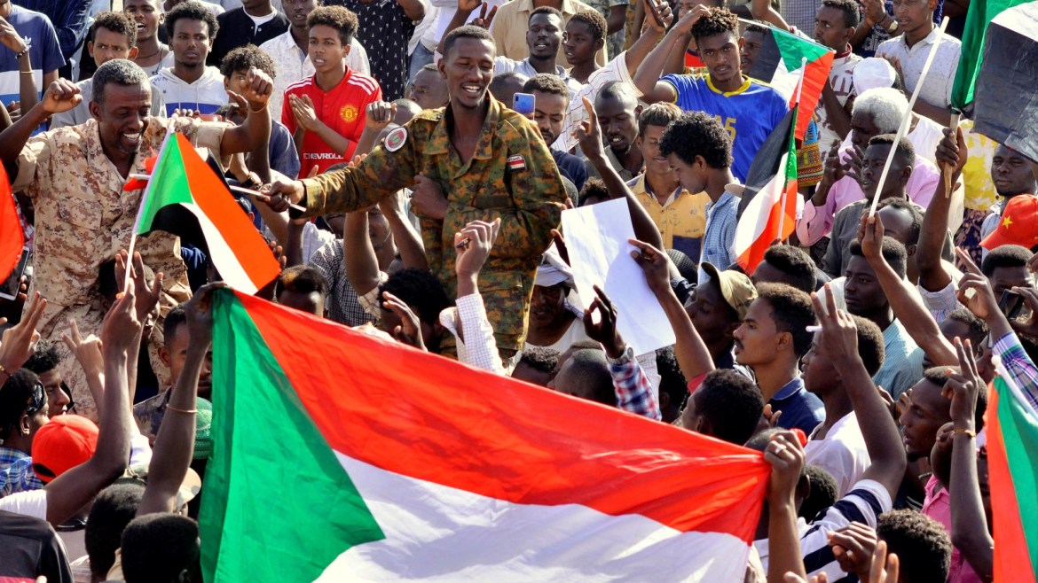Sudanese military officer joins demonstrators as they celebrate after the Defence Minister Awad Ibn Auf stepped down as head of the country's transitional ruling military council, as protesters demanded quicker political change, near the Defence Ministry in Khartoum, Sudan April 13, 2019. REUTERS/Stringer
