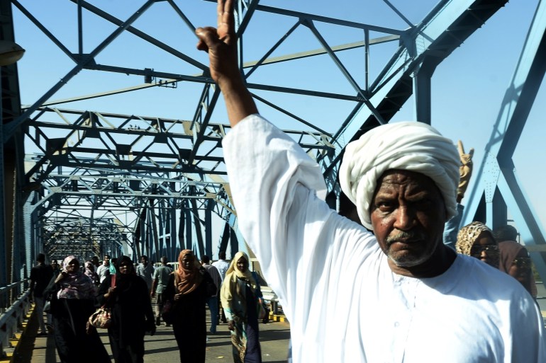 A Sudanese demonstrator gestures during a protest demanding Sudanese President Omar Al-Bashir to step down along a bridge in Khartoum, Sudan April 8, 2019. REUTERS/Stringer