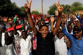 A Sudanese demonstrator flashes a two finger salute as they attend a protest rally demanding Sudanese President Omar Al-Bashir to step down outside the Defence Ministry in Khartoum, Sudan April 11, 2019. REUTERS/Stringer