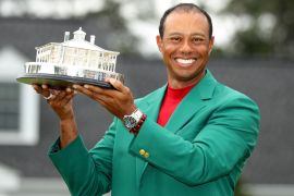 Golf - Masters - Augusta National Golf Club - Augusta, Georgia, U.S. - April 14, 2019. Tiger Woods of the U.S. celebrates with with his green jacket and trophy after winning the 2019 Masters. REUTERS/Lucy Nicholson TPX IMAGES OF THE DAY