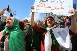 People chant slogans and carry a banner during a protest after parliament appointed upper house chairman Abdelkader Bensalah as interim president following the resignation of Abdelaziz Bouteflika in Algiers, Algeria April 9, 2019. The banner reads,