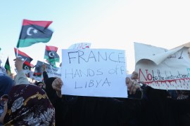 Protest in Tripoli- - TRIPOLI, LIBYA - APRIL 12 : A protestor carries a banner reading
