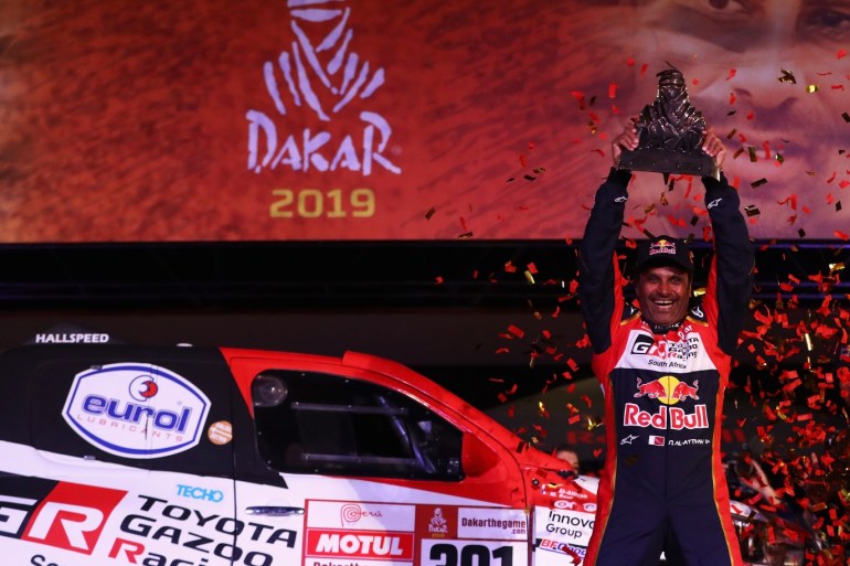 LIMA, PERU - JANUARY 17: Toyota Gazoo Racing Sa no. 301 TOYOTA HILUX car driven by Nasser Al-Attiyah of Qatar celebrates victory and their 1st place on the podium after Stage Ten and the finish of the 2019 Dakar Rally at Magdalena Beach or Playa on January 17, 2019 in Lima, Peru. (Photo by Dean Mouhtaropoulos/Getty Images)