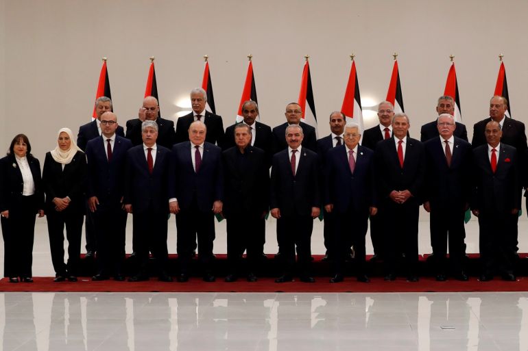 Palestinian President Mahmoud Abbas poses for a photo with members of the new Palestinian government during a swearing in ceremony, in Ramallah, in the Israeli-occupied West Bank April 13, 2019. REUTERS/Mohamad Torokman
