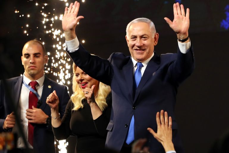 Israeli Prime Minister Benjamin Netanyahu and his wife Sara react as they stand on stage following the announcement of exit polls in Israel's parliamentary election at the party headquarters in Tel Aviv, Israel April 10, 2019. REUTERS/Ammar Awad