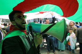 A demonstrator uses a bullhorn to shout protest slogans during a May Day march on Labour Day in Algiers, Algeria, May 1, 2019. REUTERS/Ramzi Boudina