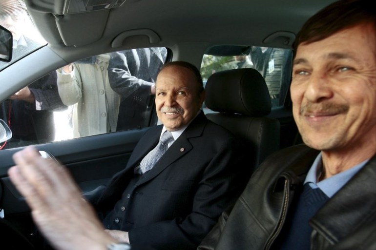 Algeria's President Abdelaziz Bouteflika smiles as he arrives with his brother Said at his campaign's communications department during a surprise visit in Algiers, Algeria April 10, 2009. REUTERS/Zohra Bensemra