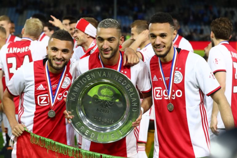 DOETINCHEM, NETHERLANDS - MAY 15: (L-R) Zakaria Labyad of Ajax, Hakim Ziyech of Ajax and Noussair Mazraoui of Ajax celebrate with the trophy after winning the Eredivisie following the Eredivisie match between De Graafschap and Ajax at Stadion De Vijverberg on May 15, 2019 in Doetinchem, Netherlands. (Photo by Dean Mouhtaropoulos/Getty Images)