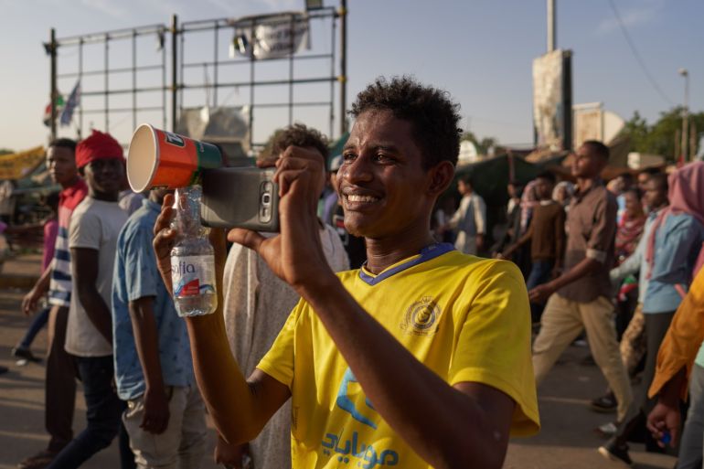 KHARTOUM, SUDAN - MAY 03: A protester pretends to do television interviews with a friend on May 03, 2019 in Khartoum, Sudan. Thousands of demonstrators continued their mass sit-in outside military headquarters in Khartoum to call on the country's military rulers to cede control. (Photo by David Degner/Getty Images)