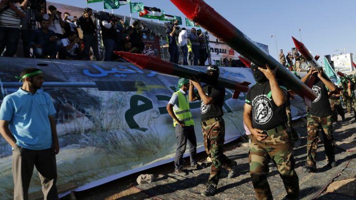 Supporters of the Jordanian Muslim Brotherhood carry mock Qassam rockets during a rally in support of Palestinians in Gaza, in Amman August 8, 2014. Israel launched its Gaza offensive on July 8 in response to a surge of rocket attacks by Gaza's dominant Hamas Islamists. Hamas said that Palestinians would continue confronting Israel until its blockade on Gaza was lifted. REUTERS/Muhammad Hamed (JORDAN - Tags: POLITICS CIVIL UNREST)