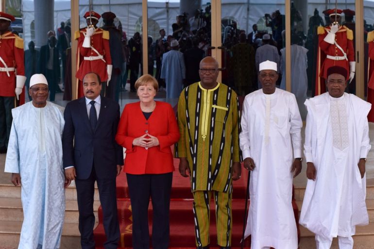 German Chancellor Angela Merkel poses for a group photo as she attends a meeting of West African leaders of the G5 Sahel, a regional force made up of soldiers from Mali, Niger, Burkina Faso, Chad and Mauritania to combat Islamist extremists in Ouagadougou, Burkina Faso May 1, 2019. REUTERS/Anne Mimault