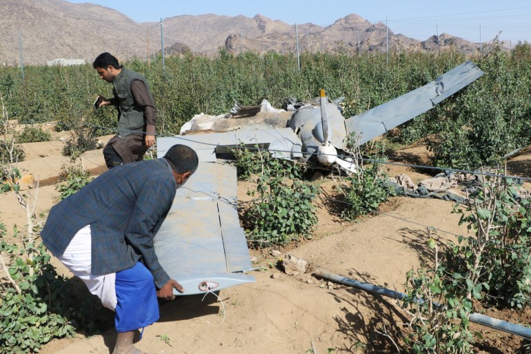 People inspect the wreckage of a drone aircraft that Houthis say they shot down near the northwestern city of Saada, Yemen April 19, 2019. REUTERS/Naif Rahma