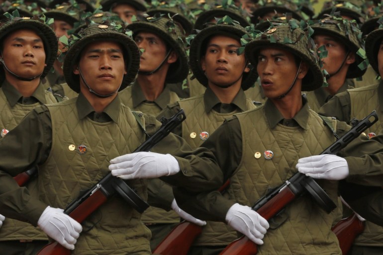 Soldiers, dressed in the old uniform of Dien Bien Phu fighters, march during the 60th anniversary celebrations of the Dien Bien Phu battle in the historic city May 7, 2014. Viet Minh forces overran the French garrison in Dien Bien Phu on May 7, 1954 after a 56-day siege, forcing the French government to abandon its colonial rule in Indochina. REUTERS/Kham (VIETNAM - Tags: POLITICS ANNIVERSARY MILITARY)
