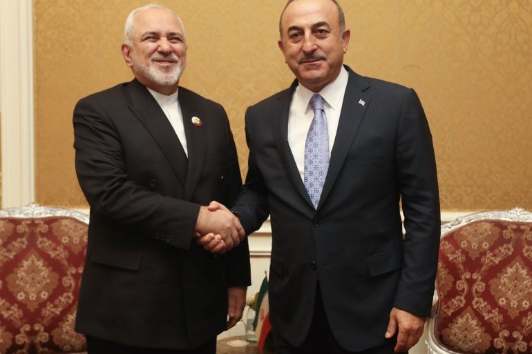 Turkish Foreign Minister Mevlut Cavusoglu in Doha- - DOHA, QATAR - MAY 1: Turkish Foreign Minister Mevlut Cavusoglu (R) meets Foreign Minister of Iran Javad Zarif (L) following the16th foreign ministers' meeting of Asian Cooperation Dialogue, in Doha, Qatar on May 1, 2019.