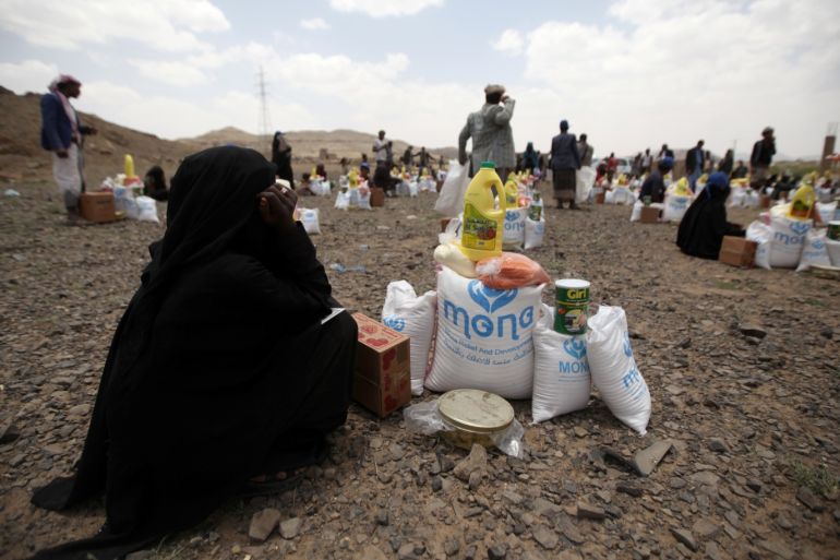 A woman sits next to food aid she received from the local charity, Mona Relief, ahead of the holy month of Ramadan on the outskirts of Sanaa, Yemen May 5, 2019. REUTERS/Khaled Abdullah