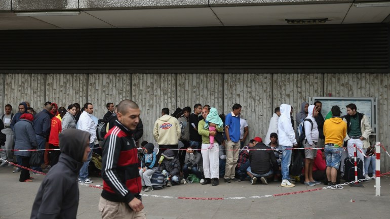 BERLIN, GERMANY - JULY 30: Migrants and refugees seeking asylum in Germany wait outside the Central Registration Office for Asylum Seekers (Zentrale Aufnahmestelle fuer Asylbewerber, or ZAA) of the State Office for Health and Social Services (Landesamt fuer Gesundheit und Soziales, or LAGeSo), on July 30, 2015 in Berlin, Germany. Migrants and refugees are arriving in Germany in record numbers with estimates ranging up to half a million by the end of 2015. The processing periods for asylum applications can take years and during that time the applicants are housed at refugee centers across the country, which is putting intense strain on both local and regional budgets as well as causing friction in smaller communities. (Photo by Sean Gallup/Getty Images)