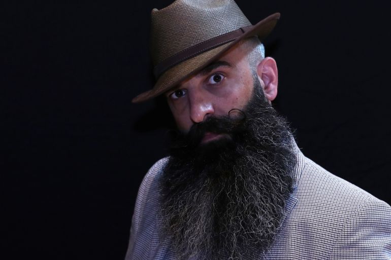 A participant of the international World Beard and Moustache Championships poses before taking part in one of the 17 categories of beard and moustache styles competing in Antwerp, Belgium May 18, 2019. ÊREUTERS/Yves Herman