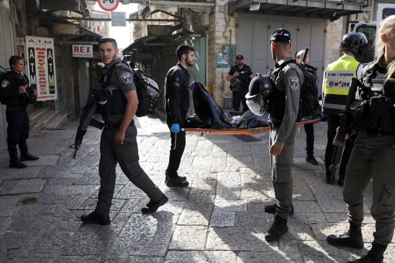 ATTENTION EDITORS - VISUAL COVERAGE OF SCENES OF DEATH OR INJURY Israeli security and rescue personnel carry a dead body following a security incident in Jerusalem's old city, May 31, 2019. REUTERS/Ammar Awad TEMPLATE OUT