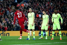 LIVERPOOL, ENGLAND - MAY 07: Divock Origi of Liverpool (27) celebrates after he scores his team's fourth goal as the Barcelona defence look on dejected during the UEFA Champions League Semi Final second leg match between Liverpool and Barcelona at Anfield on May 07, 2019 in Liverpool, England. (Photo by Clive Brunskill/Getty Images)