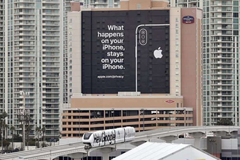 LAS VEGAS, NEVADA - JANUARY 07: A monorail train featuring a Google ad passes by a billboard advertising Apple's iPhone security during CES 2019 on January 07, 2019 in Las Vegas, Nevada. CES, the world's largest annual consumer technology trade show, runs from January 8-11 and features about 4,500 exhibitors showing off their latest products and services to more than 180,000 attendees. David Becker/Getty Images/AFP== FOR NEWSPAPERS, INTERNET, TELCOS & TELEVISION USE
