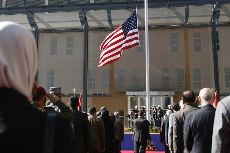 U.S. marines raise the U.S. flag during a formal opening of the new U.S. embassy in Baghdad's fortified Green Zone January 5, 2009. The United States opened its new embassy building in Baghdad on Monday, a step meant to symbolise its transition from occupying power to an ally of a sovereign Iraqi government. REUTERS/Erik de Castro (IRAQ)