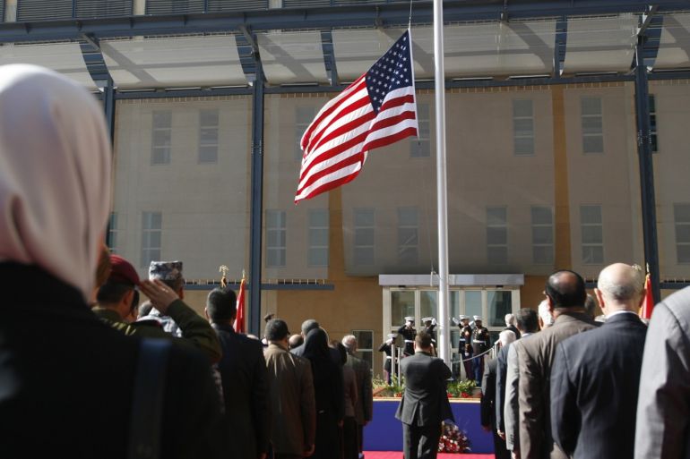 U.S. marines raise the U.S. flag during a formal opening of the new U.S. embassy in Baghdad's fortified Green Zone January 5, 2009. The United States opened its new embassy building in Baghdad on Monday, a step meant to symbolise its transition from occupying power to an ally of a sovereign Iraqi government. REUTERS/Erik de Castro (IRAQ)
