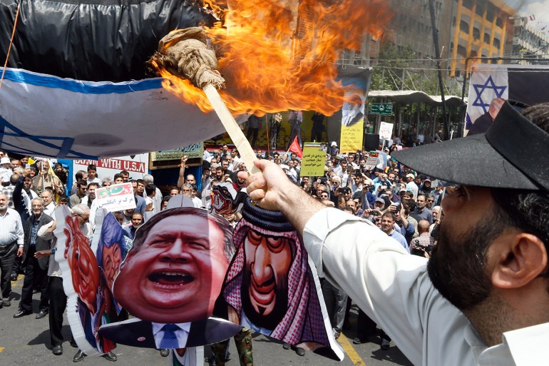 epa07614368 Iranians burn Israel flag, during an anti-Israel rally marking Al Quds Day (Jerusalem Day), in support of Palestinian resistance against Israeli in Tehran, Iran, 31 May2019. Each year Iran marks the last Friday of the fasting month of Ramadan as a solidarity day with the Palestinians. EPA-EFE/ABEDIN TAHERKENAREH