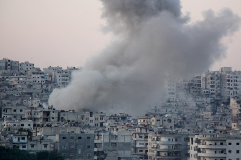 Assad regime hits Syria's Idlib- - IDLIB, SYRIA - MAY 14 : Smoke rises after an attack by Assad regime forces, before people break their fast on marketplace of Jisr al-Shughour district located inside northern Syria’s de-escalation zones, in Syria’s northwestern Idlib province on May 14, 2019. Five civilians were killed and 20 other injured in attacks.