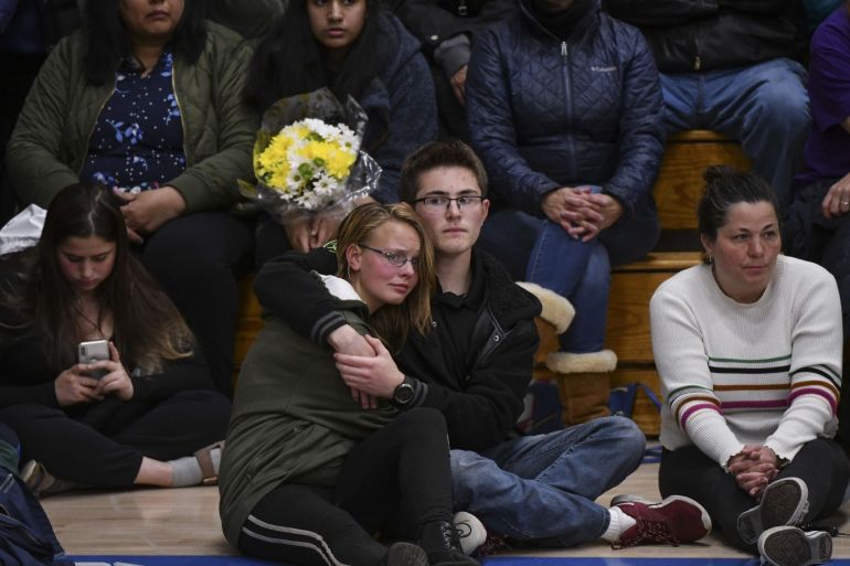 HIGHLANDS RANCH, CO - MAY 08: Students hug as Sen. Michael Bennet (D-CO) speaks during a candlelight vigil at Highlands Ranch High School on May 8, 2019 in Highlands Ranch, Colorado. One student was killed and eight others were injured during a shooting at STEM School Highlands Ranch on Tuesday. Michael Ciaglo/Getty Images/AFP== FOR NEWSPAPERS, INTERNET, TELCOS & TELEVISION USE ONLY ==