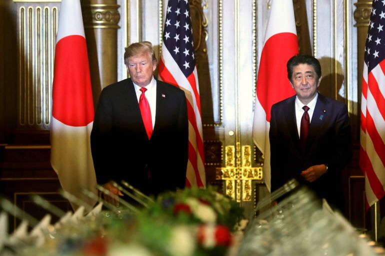 U.S. President Donald Trump and Japan's Prime Minister Shinzo Abe walk to take their seats before their working lunch in Tokyo, Japan May 27, 2019. REUTERS/Jonathan Ernst