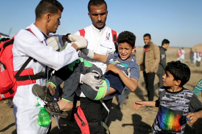 A wounded Palestinian boy is evacuated during a protest at the Israel-Gaza border fence, in the southern Gaza Strip May 3, 2019. REUTERS/Ibraheem Abu Mustafa