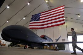 A U.S. Air Force maintainer makes his way into a hangar packed with RQ-4 Global Hawk aircraft, at an Air Force base in Arabian Gulf, March 14, 2017. REUTERS/Hamad I Mohammed