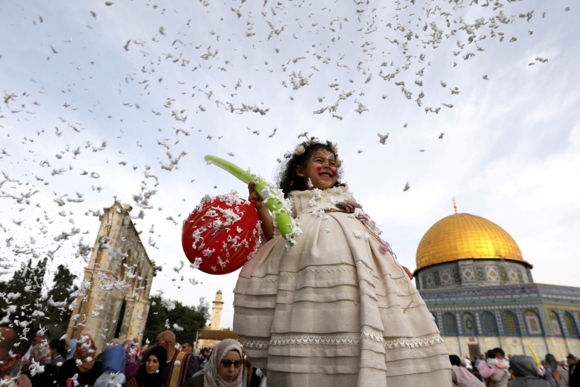Foam is sprayed as a girl smiles during celebrations after Palestinians performed Eid al-Fitr prayers which marks the end of the holy fasting month of Ramadan, on the compound known to Muslims as Noble Sanctuary and to Jews as Temple Mount in Jerusalem's Old City June 5, 2019. REUTERS/Ammar Awad TPX IMAGES OF THE DAY