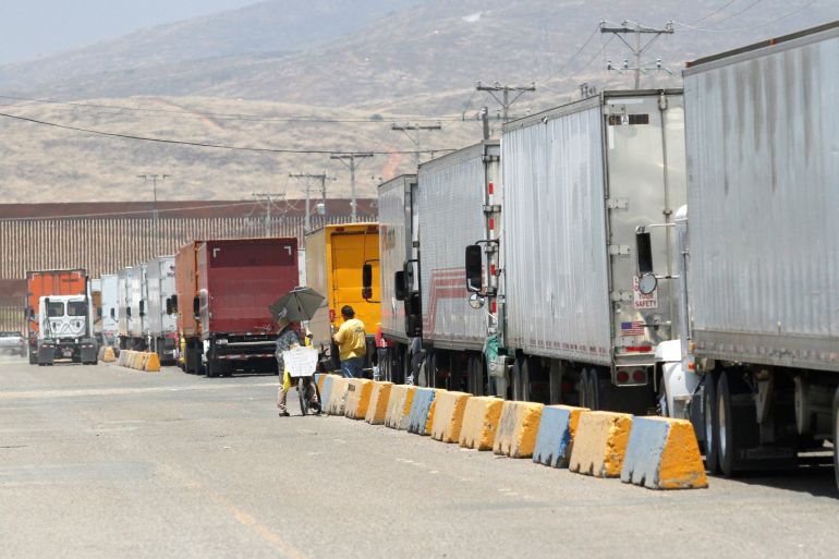 Trucks wait in queue for border customs control, to cross into the U.S., at the Otay border crossing in Tijuana, Mexico June 7, 2019. REUTERS/Jorge Duenes