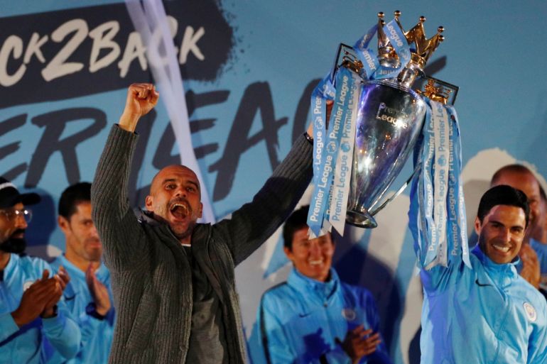 Soccer Football - Manchester City Premier League Title Celebrations - Etihad Stadium, Manchester, Britain - May 12, 2019 Manchester City manager Pep Guardiola and assistant coach Mikel Arteta celebrate winning the Premier League with the trophy REUTERS/Phil Noble