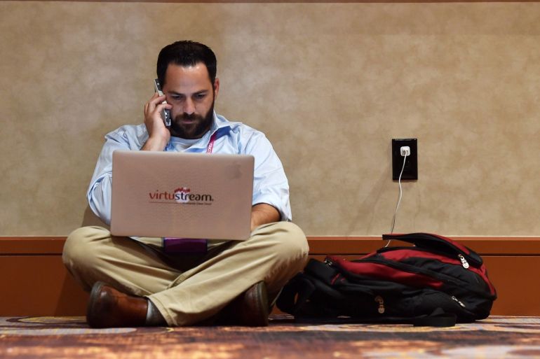 An attendee uses his laptop computer and mobile phone during the 2016 Black Hat cyber-security conference in Las Vegas, Nevada, U.S. August 3, 2016. REUTERS/David Becker