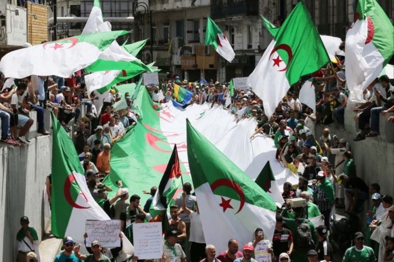 epa07663853 Algerian protesters wave national flags during the weekly protest in Algiers, Algeria, 21 June 2019. Algerians have been staging protests since the resignation of president Abdelaziz Bouteflika demanding the departure of all figures of the former regime. EPA-EFE/STRINGER