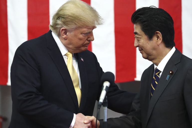 YOKOSUKA, JAPAN - MAY 28: U.S. President Donald Trump shakes hands with Japan's Prime Minister Shinzo Abe during delivering a speech to Japanese and U.S. troops as they aboard Japan Maritime Self-Defense Force's (JMSDF) helicopter carrier DDH-184 Kaga at JMSDF Yokosuka base on May 28, 2019 in Yokosuka, Kanagawa, Japan. U.S President Donald Trump is on a four-day state visit to Japan, the first official visit of the Reiwa era. (Photo by Athit Perawongmetha - Pool/Gett