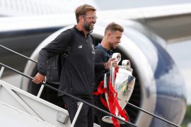 Soccer Football - Champions League - Liverpool arrive back in Liverpool - Liverpool, Britain - June 2, 2019 Liverpool's Jordan Henderson and manager Juergen Klopp descend the stairs from an aeroplane with the trophy as they arrive back in Liverpool after winning the Champions League Final Action Images via Reuters/Craig Brough