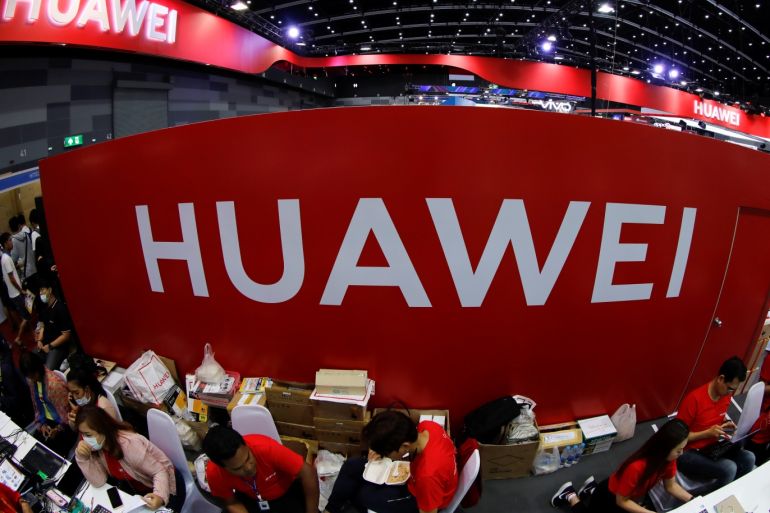 Workers sit at the Huawei stand at the Mobile Expo in Bangkok, Thailand May 31, 2019. Picture taken May 31, 2019. REUTERS/Jorge Silva
