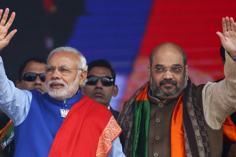 Indian Prime Minister Narendra Modi (L) and Amit Shah, the president of India's ruling Bharatiya Janata Party (BJP), wave to their supporters during a campaign rally ahead of state assembly elections, at Ramlila ground in New Delhi in this January 10, 2015 file photo. Modi will have to reverse course and engage with opposition leaders if he is to salvage his economic reform program, senior aides said on November 9, 2015, after he suffered a humiliating state election defeat. REUTERS/Anindito Mukherjee/Files