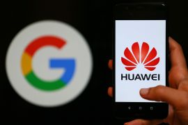 Huawei logo- - IZMIR, TURKEY - MAY 28: A person holds a Huawei mobile phone in front of logo of Google in Izmir, Turkey on May 28, 2019.