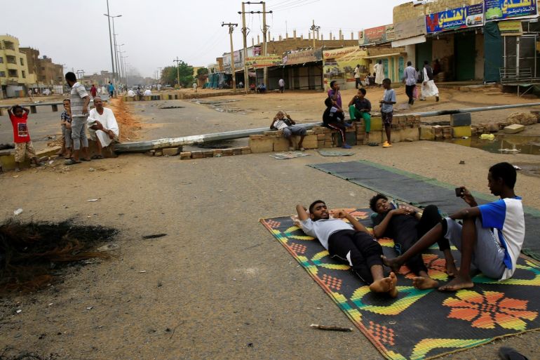 Sudanese protesters rest on a mat on a barricaded street, demanding that the country's Transitional Military Council handover power to civilians, in Khartoum, Sudan June 4, 2019. REUTERS/Stringer