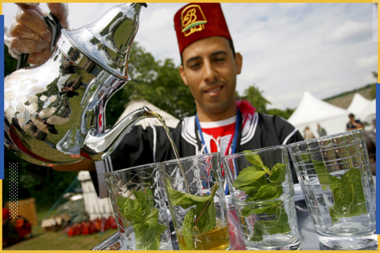 epa01353997 Chafai, a Moroccan tea vendor, serves pepermint tea during the 20th Africa Festival in Wuerzburg, Germany, 22 May 2008. The Africa Festival is an annual music event, attracting about 100,000 visitors. The festival runs until 25 May. EPA/