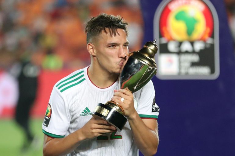 Soccer Football - Africa Cup of Nations 2019 - Final - Senegal v Algeria - Cairo International Stadium, Cairo, Egypt - July 19, 2019 Algeria's Ismael Bennacer celebrates winning the Best Young Player of the Tournament with the trophy REUTERS/Suhaib Salem