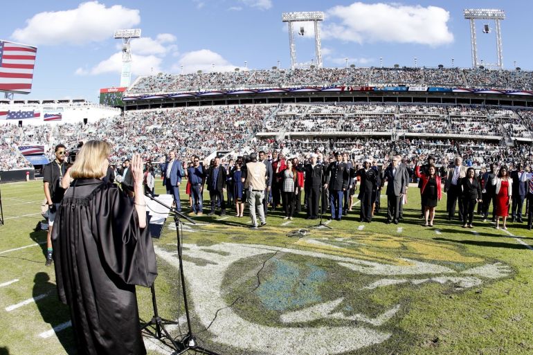Dec 16, 2018; Jacksonville, FL, USA; New citizens of the United States take the Oath of Citizenship in a half time swearing in ceremony conducted by the Honorable United States District Court judge Marcia Morales Howard (left) at TIAA Bank Field during a game between the Jacksonville Jaguars and the Washington Redskins. Mandatory Credit: Reinhold Matay-USA TODAY Sports