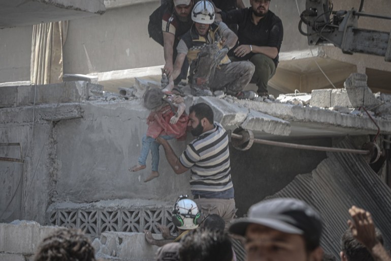 Airstrikes hit Syria's Idlib : 9 dead- - IDLIB, SYRIA - JULY 27: Civil defence crews rescue a child from the wreckage after airstrikes of Assad Regime and Russia over Arihah district within the de-escalation zone of Idlib, Syria on July 27, 2019. At least 9 civilians were reported dead and 27 others injured.