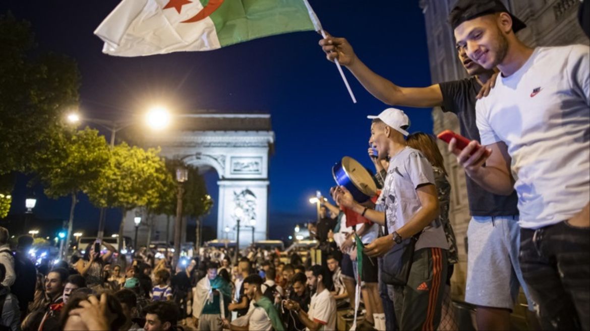 epa07728278 Algeria supporters celebrate on the Champs-Elysees, near the Arc de Triomphe, after Algeria won the 2019 Africa Cup of Nations (AFCON2019) final soccer match against Senegal, in Paris, France, 19 July 2019. The 2019 Africa Cup of Nations (AFCON2019) was taking place from 21 June until 19 July 2019 in Egypt. EPA-EFE/IAN LANGSDON