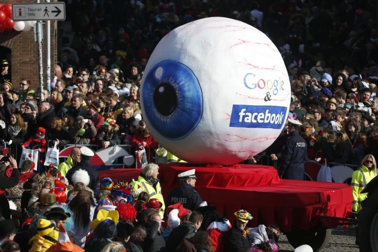 A carnival float with a papier-mache caricature representing Google and Facebook takes part in the traditional Rose Monday carnival parade in the western German city of Duesseldorf February 16, 2015. The Rose Monday parades in Cologne, Mainz and Duesseldorf are the highlight of the German street carnival season. REUTERS/Ina Fassbender (GERMANY - Tags: POLITICS SOCIETY)