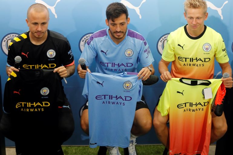English Premier League Manchester City Football Club captain David Silva poses with teammates Angelino (L) and Oleksandr Zinchenko during a promotional event in Hong Kong, China July 23, 2019. REUTERS/Tyrone Siu